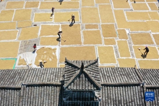 9月16日，村民在貴州省黔東南苗族侗族自治州從江縣剛邊壯族鄉(xiāng)三聯(lián)村晾曬稻谷（無人機照片）。