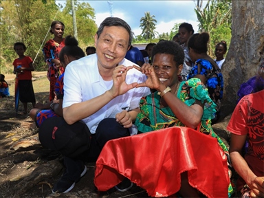 2023年12月18日，中國駐瓦努阿圖大使李名剛和前來觀看瓦努阿圖公路項目二期馬勒庫拉段移交儀式的當?shù)鼐用窈嫌?。人民網(wǎng) 賀吉攝