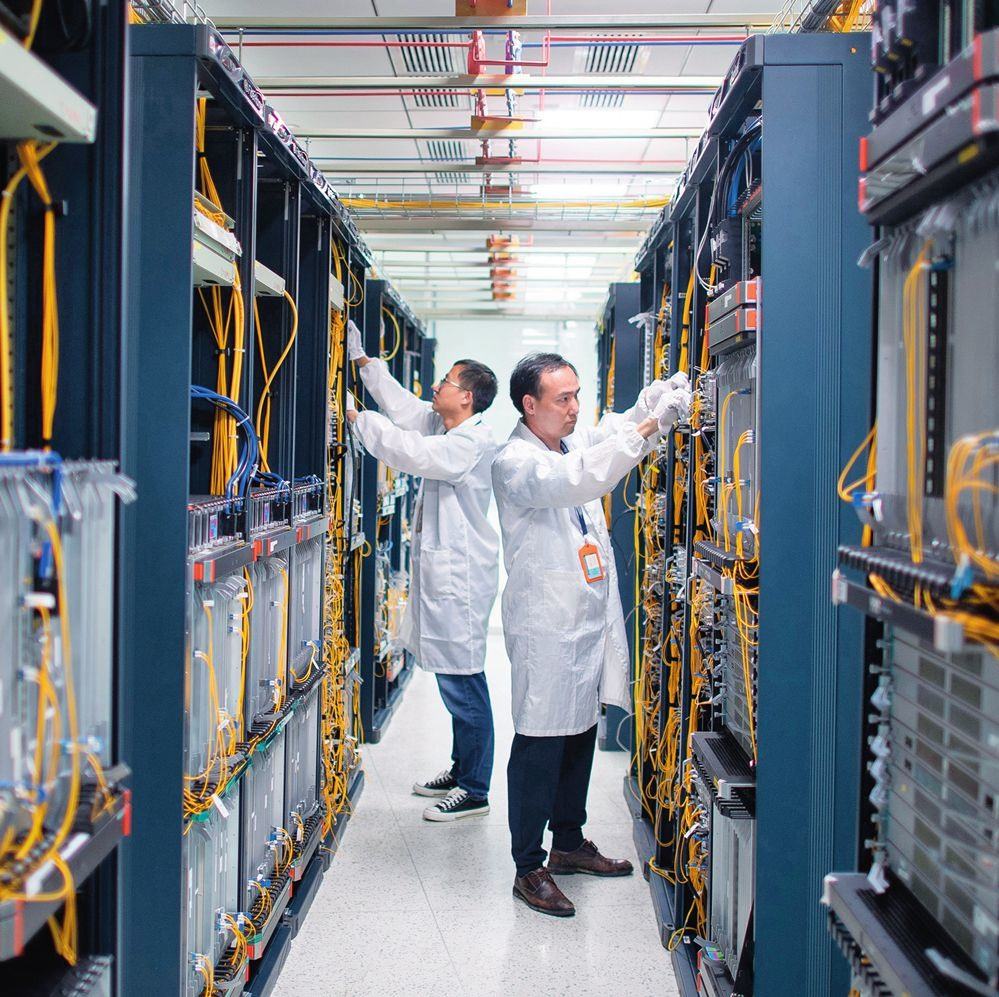 在位于武漢中國光谷的光電器件研發(fā)制造商——武漢光迅科技股份有限公司生產(chǎn)車間內(nèi)，技術(shù)人員在光模塊生產(chǎn)線作業(yè)（2023年4月11日攝）。程敏攝/本刊