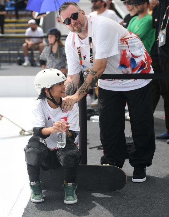 6月20日，鄭好好（左）在比賽間隙與教練互動，她在預(yù)賽中最佳成績?yōu)?2.60分。當(dāng)日，巴黎奧運會資格系列賽布達(dá)佩斯站滑板女子碗池預(yù)賽在布達(dá)佩斯舉行。新華社記者 賀燦鈴 攝