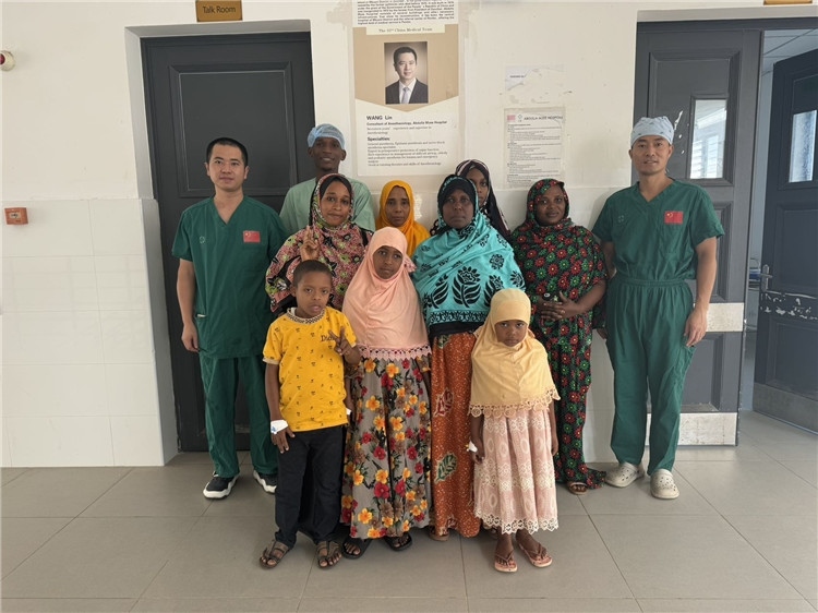 李廣（右一）和王林醫(yī)生與部分患者合影。中國援桑醫(yī)療隊供圖