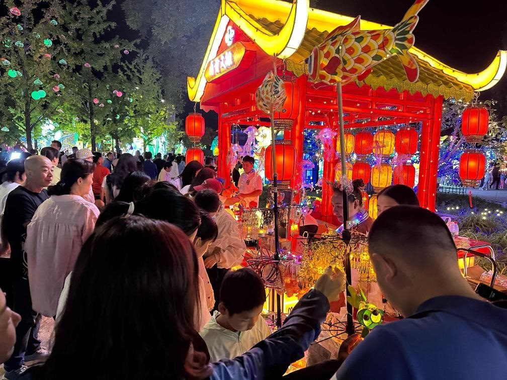市民游客在2024年北京中秋國慶彩燈游園會上選購特色文創(chuàng)商品。新華社記者楊淑君 攝