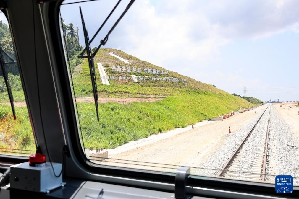5月6日，在馬來西亞彭亨州馬東鐵項目沿途的山坡上，兩行中文和馬來文大字“共商共建共享，共創(chuàng)美好未來”映入眼簾。新華社記者 程一恒 攝