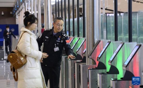1月2日，大興機(jī)場(chǎng)邊檢站警察指導(dǎo)旅客使用自助出境設(shè)備。新華社記者 李欣 攝