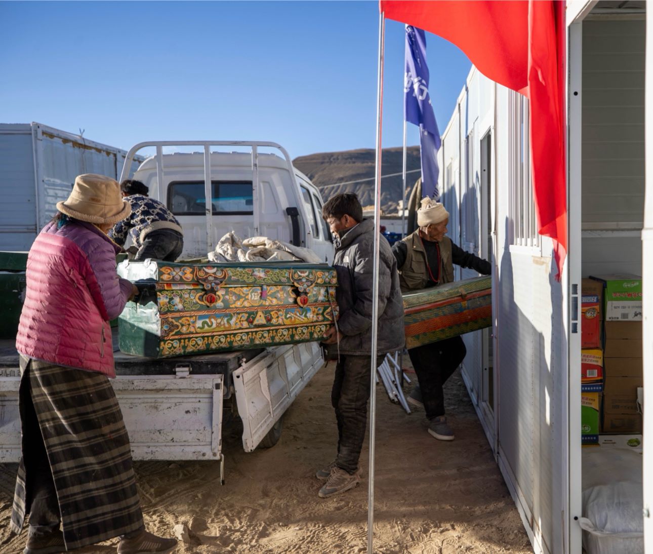 1月11日，西藏定日縣曲洛鄉(xiāng)措昂村，首批入住活動板房的村民正在搬運物品，為入住做準(zhǔn)備。人民日報記者張武軍攝