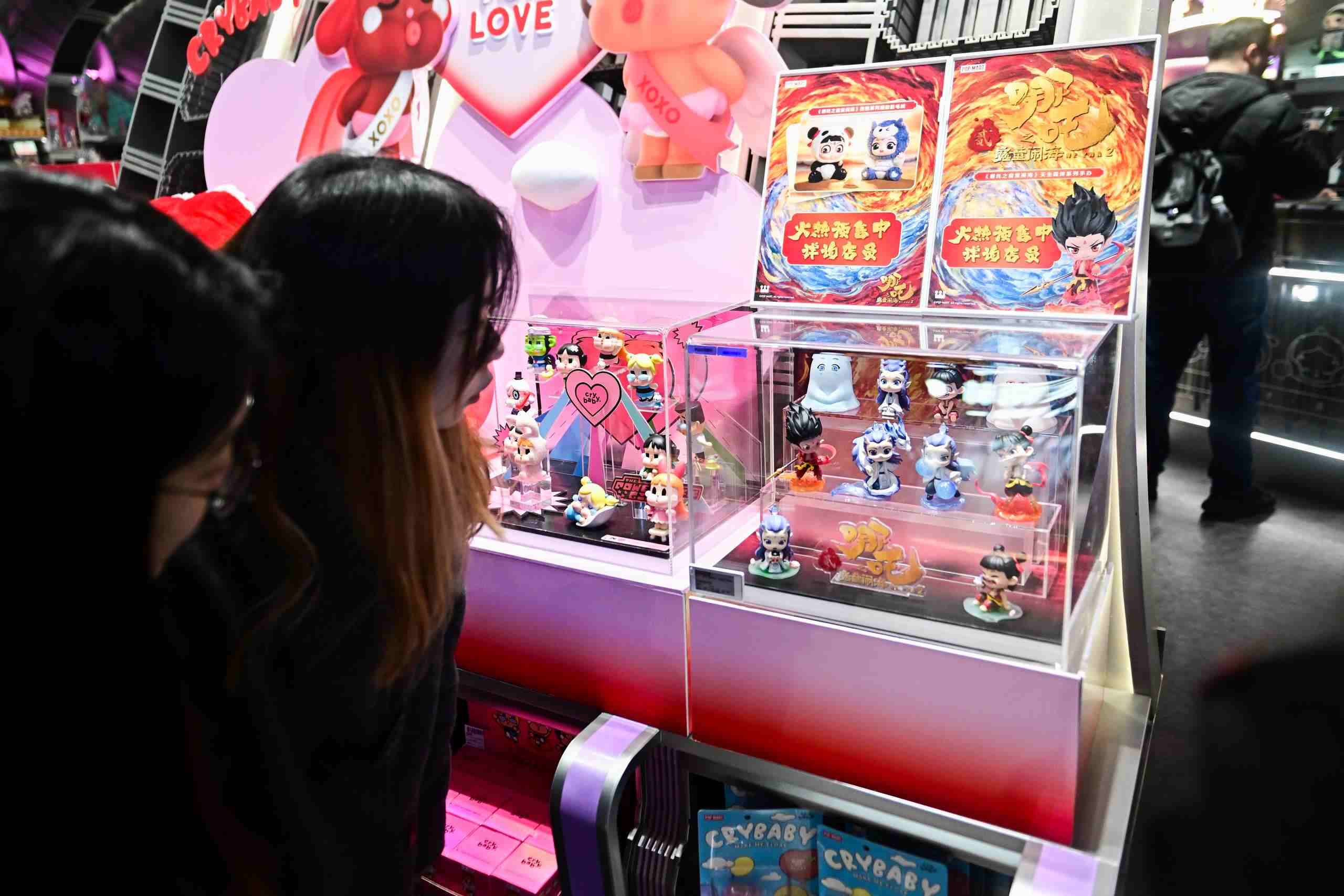 △2025年2月22日，上海，市民在圍觀《哪吒之魔童鬧?！废嚓P(guān)手辦盲盒。