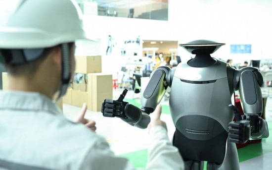 在廣汽研究院，人形機器人團隊的周仁義在演示GoMate機器人互動功能（新華社記者 鄧華 攝）