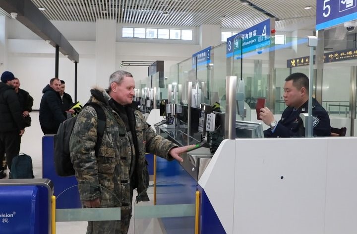 2024年12月10日，在黑河公路口岸旅檢大廳，黑河出入境邊防檢查站民警為首班次客車入境旅客辦理邊檢通關手續(xù)。當日，中國黑河公路口岸—俄羅斯卡尼庫爾干公路口岸旅客運輸正式開通。新華社發(fā)（劉松攝）